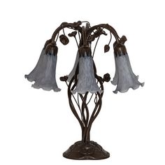 a lamp that is on top of a stand with three lights in the shape of flowers