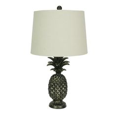 a pineapple lamp with a white shade on the base and a black metal base