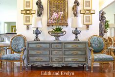 an old dresser with two chairs and a vase on it in the middle of a room