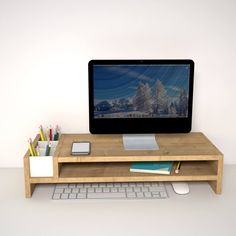 a computer monitor sitting on top of a wooden desk next to a keyboard and mouse