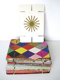 a stack of multicolored notebooks sitting next to each other on a table