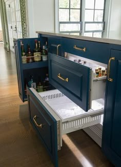 an open cabinet in the middle of a kitchen