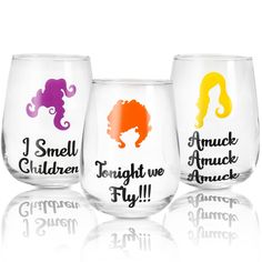 three wine glasses that have different colored designs on them, one with the words i smell children