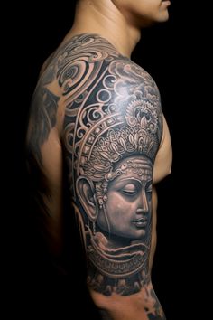 a man with a tattoo on his arm and shoulder is wearing a headdress