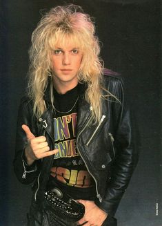 a man with long blonde hair wearing a black leather jacket and holding a baseball glove