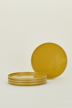 three yellow plates stacked on top of each other