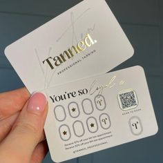 a person holding up a white business card