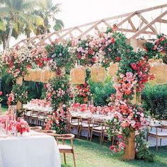 an outdoor dining area with tables and chairs set up for a formal function in the grass