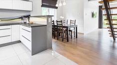 an open kitchen and dining room with stairs