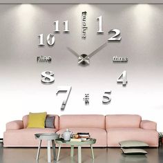 a living room filled with furniture and a large clock on the wall above it's face