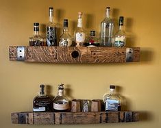 two wooden shelves holding liquor bottles and glasses