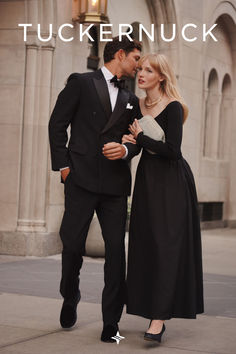 a man in a tuxedo standing next to a woman wearing a black dress