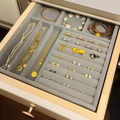 a drawer filled with lots of different types of jewelry