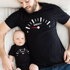 a man laying on top of a bed next to a baby