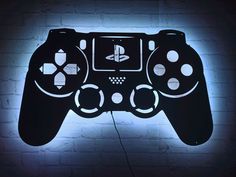 a video game controller lit up against a brick wall