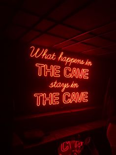 a red neon sign that says what happens in the cave stays in the cave on it