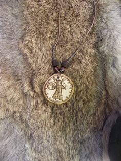 a close up of a necklace on a fur coat