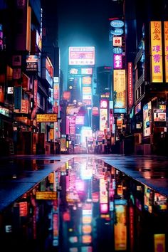 a city street at night with neon signs and buildings reflected in the wet puddles