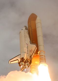 a space shuttle taking off from the launch pad