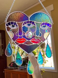 a stained glass heart hanging from a chain