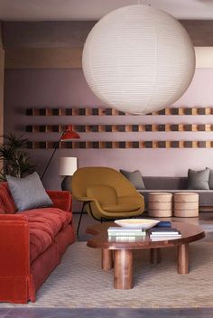 a living room filled with furniture and a large white ball hanging over the top of it