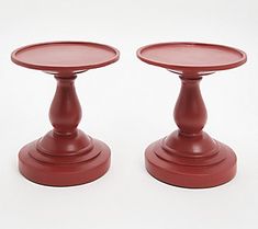 two red candlesticks sitting on top of each other