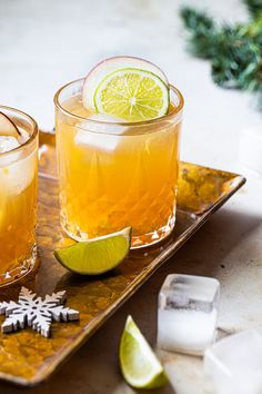 two glasses filled with drinks sitting on top of a tray