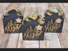 three black and gold christmas decorations with the words gifts of the magi on them