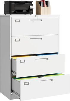 an office file cabinet with three drawers and a printer on the top shelf next to it