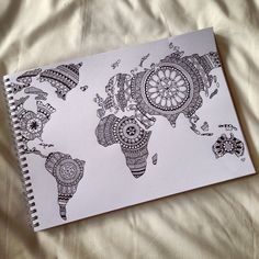 a notebook with an intricate world map drawn on it