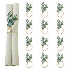 a bunch of napkin rings with flowers on them and tied to the back of each one