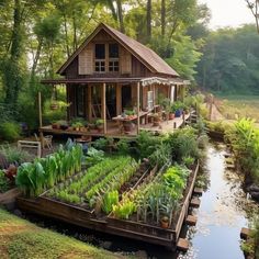 a small wooden house sitting on top of a lush green hillside next to a river