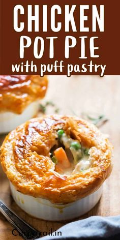 chicken pot pie with puff pastry on a cutting board next to a knife and fork