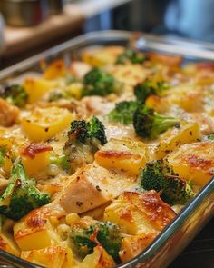 a casserole dish with chicken, broccoli and potatoes in it on a table