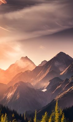 the mountains are covered in clouds and trees