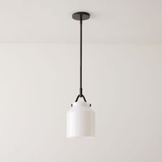 a white light hanging from a ceiling in a room