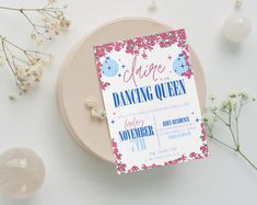 a dancing queen birthday party with pink and blue florals on the table next to flowers