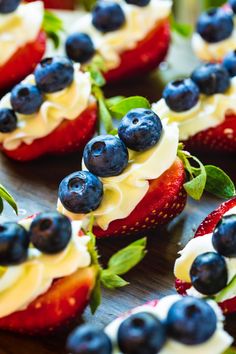 strawberries with whipped cream and blueberries on them