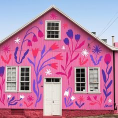 a pink house with flowers painted on it