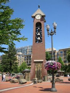 a tall clock tower sitting in the middle of a park