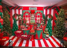 a christmas themed dessert table with red and green balloons