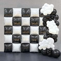 black and white balloons are arranged in the shape of a checkerboard