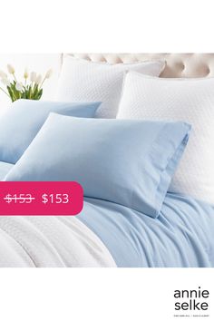 a bed with blue sheets and pillows on it for $ 15 95 at annie selke