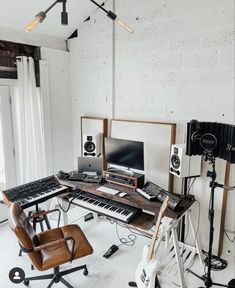 a room with a keyboard, chair and other musical equipment