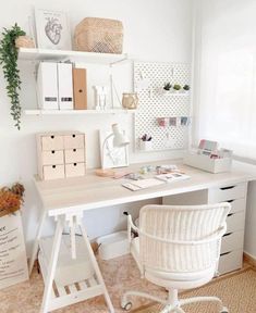 a white desk and chair in a room with lots of shelves on the wall above it