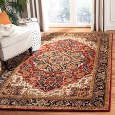 a living room area with a large rug on the floor and a chair in front of it