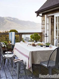 an outdoor table and chairs on a wooden deck