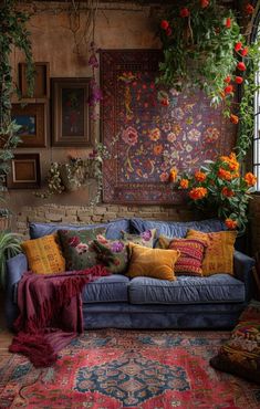 a living room filled with lots of furniture and flowers hanging from the wall above it