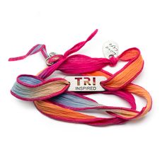 Pink TRI Inspired plate on silk wrap bracelet - This fun, beautiful silk wrap bracelet is approximately 26” in length. Silk is hand dyed with pink/orange/blue/purple blend. Features a LOVE LIFE charm knotted onto the wrap along with a button clasp. Silk is slightly stretchy and can be wrapped around wrist several times. Ironman Jewelry, Marathon Gift, Swim Bike Run