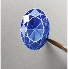 a blue diamond being cut into smaller pieces with a wooden stick in front of it